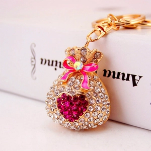 Sparkling crystal fortune bag keychain with pink enamel bow on golden alloy ring