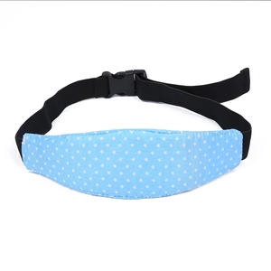 Detail of adjustable blue baby head support strap with white stars for car seats