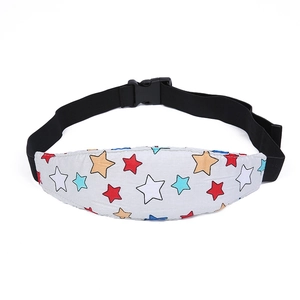 Close-up of baby car seat sleep strap with colorful star pattern and safety buckle