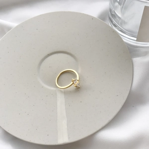 Detail of a gold plated S925 silver ring featuring two step-cut clear zircon stones
