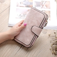 Close-up of pink embroidered long wallet with gold zipper and textured synthetic leather