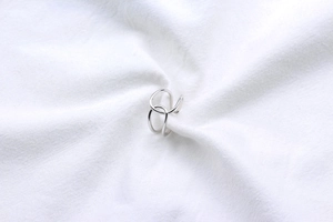Macro detail of polished S925 sterling silver ring with double crisscross line design