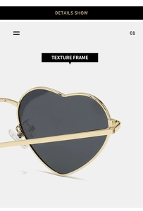 Detail of metal hinge and texture of heart shaped golden frame sunglasses