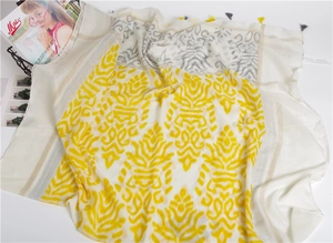 Detail of Harajuku style scarf featuring wave prints and yellow fringe tassels on cotton linen