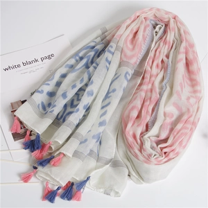 Detail view of cotton linen shawl scarf with wave prints and bicolored handmade tassels