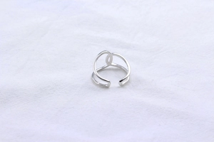 Detail of minimalist S925 sterling silver ring with double-layered crossover design