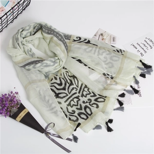 Detail of bohemian cotton linen scarf with geometric wave patterns and fringe tassels