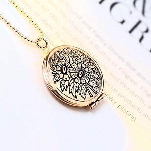 Vintage golden oval locket necklace with floral engraving and metal bead chain