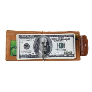 Macro view of brown leather bifold wallet featuring a built-in metal money clip and card slots