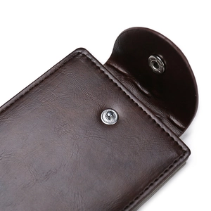 Detail of brown leather wallet featuring a secure snap button closure and vintage texture