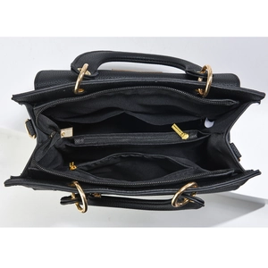 Internal view of black crossbody bag with multi-layer compartments and gold hardware detail