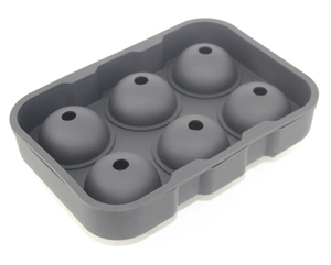 Macro detail of a 6-hole gray silicone mold for making spherical ice cubes