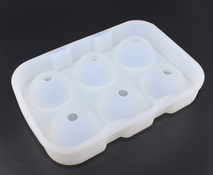 Detail of translucent white 6-cavity spherical silicone ice mold with top fill holes