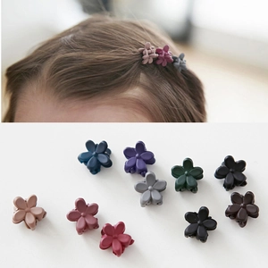 Detail of mini matte floral hair clips in various Morandi colors for hair styling