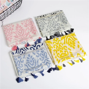 Detailed view of bohemian style scarves with ethnic patterns and handmade tassel fringes