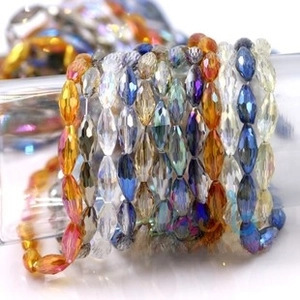 Macro shot of faceted multi-colored glass beads on a metal chain for DIY jewelry