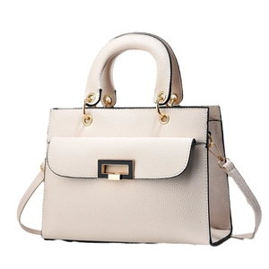 Front view of a beige lychee leather handbag with a rectangular gold buckle and strap