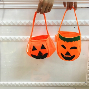 Halloween orange felt tote bags with black jack-o'-lantern face for party decorations
