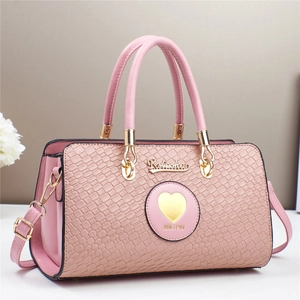 Pink faux leather handbag with woven texture panel and gold hardware details