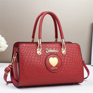 Elegant red woven texture handbag for women with gold hardware and shoulder strap