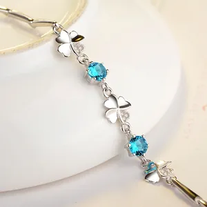 Close-up of S925 silver clover bracelet with blue zircons and polished chain links
