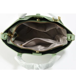 Top view of spacious interior layers and chevron lining of light green handbag