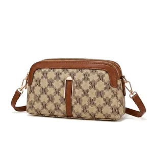 Detail view of retro M-pattern monogram handbag with gold hardware and zipper