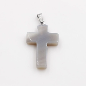 Detail of grey agate cross pendant with natural stone texture and silver bail