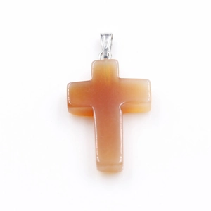 Detailed close-up of a natural orange-red stone cross pendant with silver metal bail