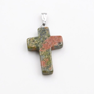 Detailed view of the red and green natural stone cross pendant with silver metal bail