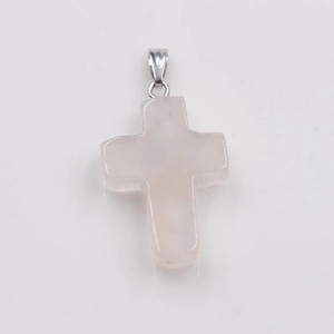 Close-up of a natural rose quartz stone cross pendant with silver metal bail