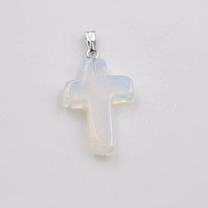 Detailed view of an opal cross pendant with a polished silver metal bail on white background