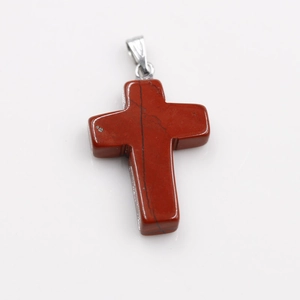 Detailed view of red natural stone cross pendant with unique black marble texture