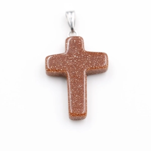 Detailed view of a red-brown gold sandstone cross pendant with silver metal bail