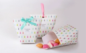 Detail of colorful water drop pattern gift boxes with ribbons and thank you labels