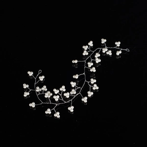 Detail of bridal headband with white pearls and silver wire branch-like texture