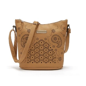 Detail of laser-cut hollow pattern on brown PU leather crossbody bag with metal zipper