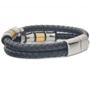 Detail of double-layer woven black leather bracelet with silver and gold magnetic clasp