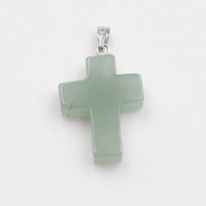 Detail view of a light green natural stone cross pendant with silver metal bail