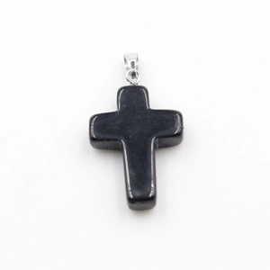 Detailed view of a black obsidian cross pendant with polished finish and silver bail