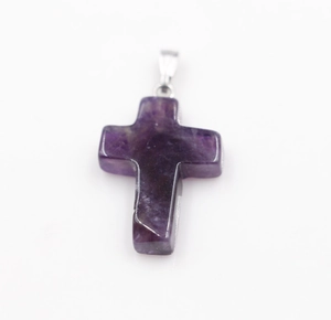 Close-up of a purple natural amethyst cross pendant with a silver metal clasp hook