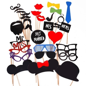 Wedding party photo booth props set with glitter paper lips, ties, and glasses on sticks