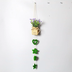 Close-up of rustic wall-hanging faux plant with purple flowers and green flocking charms