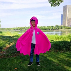 Detail of pink hooded cape for kids with skull patch and jagged hem for Halloween