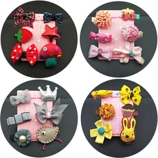 Detail view of 4 sets of colorful fabric flower hair clips for girls on black leather back