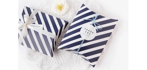 Blue and white diagonal stripe pillow box with ribbons and Thank You sticker decoration