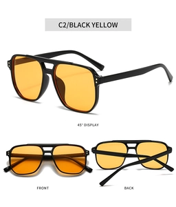 Detail view of double bridge square sunglasses with yellow lenses and rivet accents