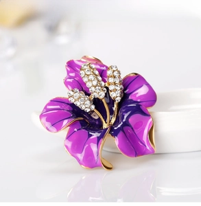 Macro view of purple rose brooch with gradient petals and sparkling white crystals