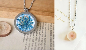 Close-up of dried flower pendants in round and hexagon shapes with silver chains