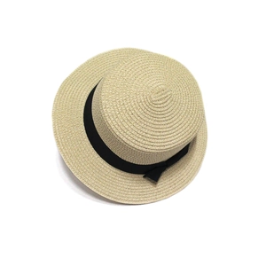 Women's beige straw boater hat with black ribbon bow for summer beach sun protection